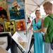 Danielle Ferracciolo, 20, of Ypsilanti, smiles at her brother Derek, 15, of Ypsilanti, as they browse through artwork at the Ann Arbor Street Art Fair, Friday, July 19, 2013. Melanie Maxwell | AnnArbor.com